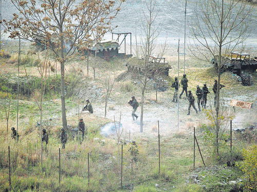 Soldiers search for militants as smoke rises from a bunker after a gunfight in Mohura in Uri on Friday. Reuters