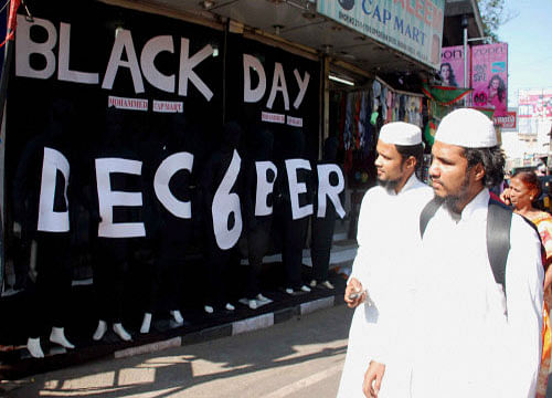 shopkeeper puts a banner with 6th December as Black day written on it to mark 22nd Anniversary of the Babri Masjid demolition, in Hyderabad. PTI photo