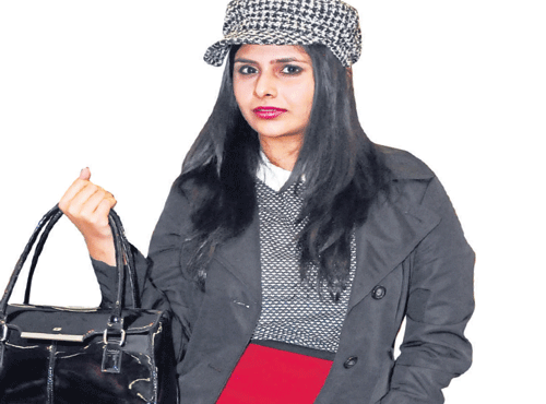 Nikita Sakhrani,  a first-year BCom student of Jain College, showcased a chic fashionista look by wearing a monochrome blouse, a red skirt, a black water-resistant coat and black stockings with a houndstooth hat and a black handbag. DH photo