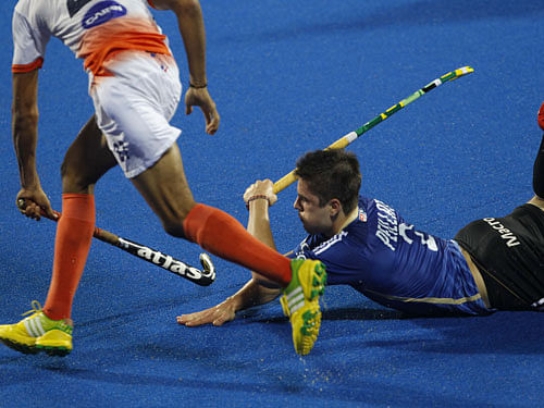 Argentina's Gonzalo Peillat, on ground, tries to take the ball from India's Akashdeep Singh, during the Champions Trophy field hockey match in Bhubaneswar, India, Sunday, Dec.7, 2014. AP Photo
