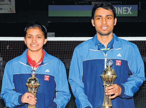 Rituparna Das (left) and Saurabh Verma of ONGC with their spoils after winning the PSPB inter-unit badminton championship in Bengaluru on Sunday. DH PHOTO