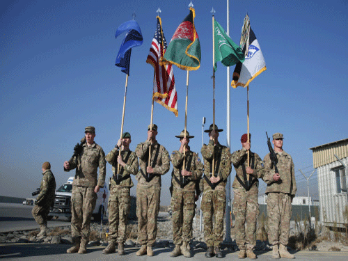 International Security Assistance Forces take part in a ceremony north of Kabul International Airport in Kabul, Afghanistan. The U.S. and NATO ceremonially ended their combat mission in Afghanistan on Monday, 13 years after the Sept. 11 terror attacks sparked their invasion of the country to topple the Taliban-led government. AP photo