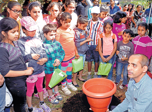 Children taking part in pottery and (right) clay-modellingworkshops.