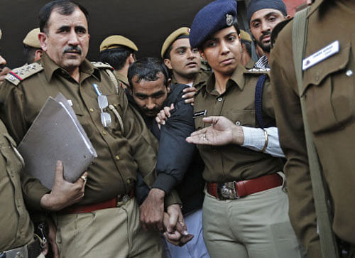 Policemen escort driver Yadav who is accused of a rape outside a court in New Delhi. Reuters
