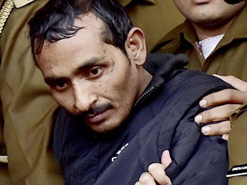 Police take away rape accused taxi driver Shiv Kumar Yadav after he was produced before a Magistrate Court in New Delhi on Monday. Police arrested Yadav in Mathura on December 7 for allegedly raping a 25-year-old female executive on Friday night in Delhi. PTI Photo