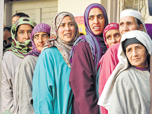 Womenwait in queue to cast their votes at a polling station in Budgam,Jammuand Kashmir, on Tuesday. PTI