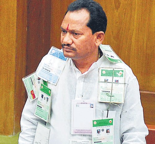 BJP MLA Prabhu Chavan sports a garland of ration cards in the Legislative Assembly onWednesday.