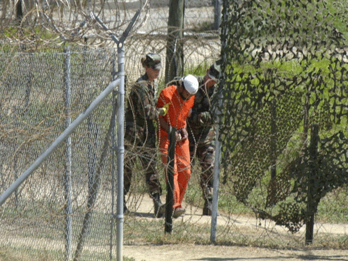 A detainee is escorted by U.S. military guards to be interrogated at the detention facility Camp X-Ray on Guantanamo Bay U.S. Naval Base in Cuba. The US is facing a tough time to defend its human rights record which is being questioned by many countries, including some of its allies, following the release of a damaging report on CIA's detention and interrogation programmes. AP file photo