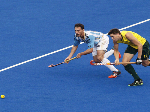 rgentina's Ignacio Ortiz, left and Australia's Captain Eddie Ockenden compete for the ball during the Champions Trophy field hockey quarter final match in Bhubaneswar. AP Photo