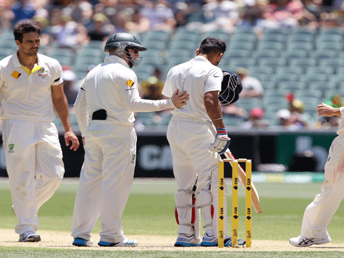With memories of the late batsman Phillip Hughes still fresh, the Australian team Thursday rushed to the aid of Indian captain Virat Kohli after he was hit by a bouncer on the helmet during third day of the first Test match between India and Australia at the Adelaide Oval here. AP Photo