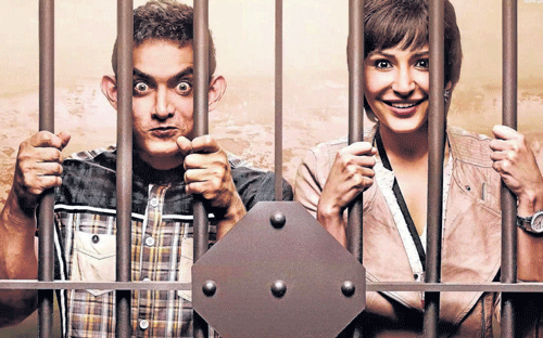 Actors AamirKhan and Anushka Sharma in their upcoming film'PK'; (below) poster of the film.