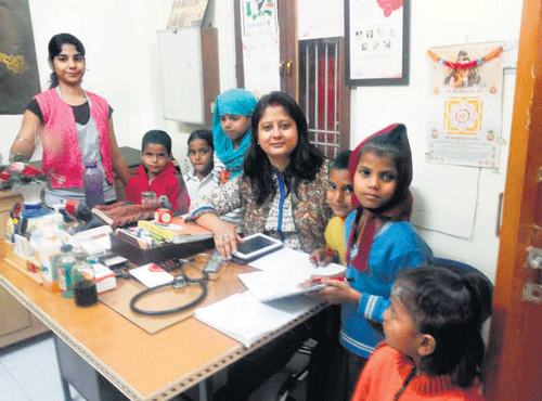 Dr Shipra Dhar Srivastava in her hospital in Varanasi with childrenwhom she is helping to study in schools.