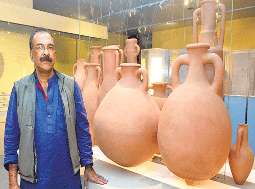 Dr P J Cherian stands beside some excavated articles at the exhibition