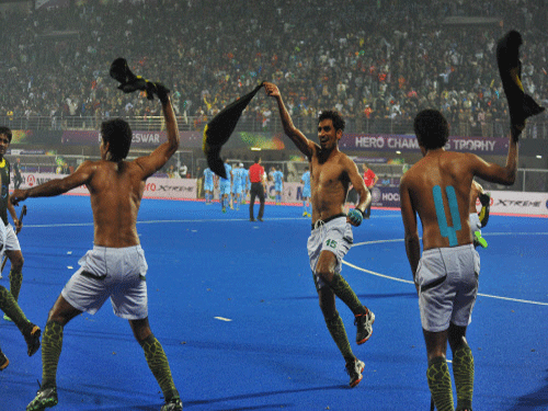 Pakistan players celebrate after beating India by 4-3 during the second semifinal match of the Champions Trophy. The International Hockey Federation (FIH) today suspended two Pakistani players Amjad Ali and Mohammad Tousiq from playing in the Champions Trophy final after they were found guilty of making obscene gestures towards spectators following their semi-final win against India. PTI phot