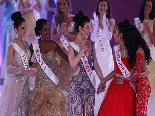 From left, Miss India Koyal Rana, Miss Kenya, Idah Nguma, Miss Brazil, Julia Gama, Miss Indonesia Maria Asteria Sastrayu Rahajeng, and Miss Malaysia, Dewi Liana Seriestha, celebrate, after winning the charity section of the Miss World competition, at the ExCel centre in London, Sunday, Dec. 14 2014. AP Photo/