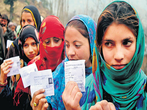 My vote my right: Voters stand in queue to exercise their franchise in the 4th phase of the Assembly elections at Shangus in south Kashmir on Sunday. pti
