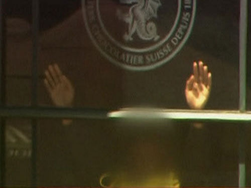 A Sydney-based radio presenter Monday said he spoke to one of the hostages being held inside a cafe here and he could hear the gunman talking in the background. Hands are pressed up against the window of the Lindt cafe, where hostages are being held, in this still image taken from video from Australia's Seven Network. Reuters photo