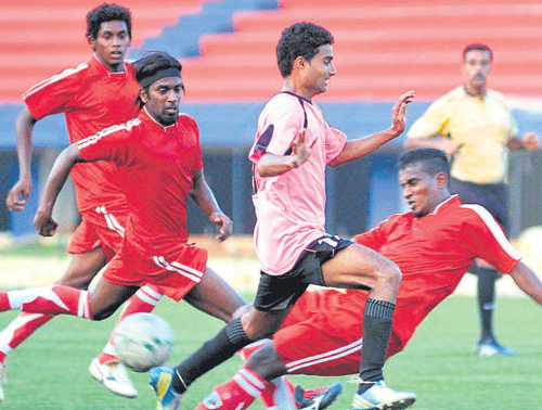 crunching tackle: South United's Sudharshan (centre) tries to move past CIL's defenders. dh photo