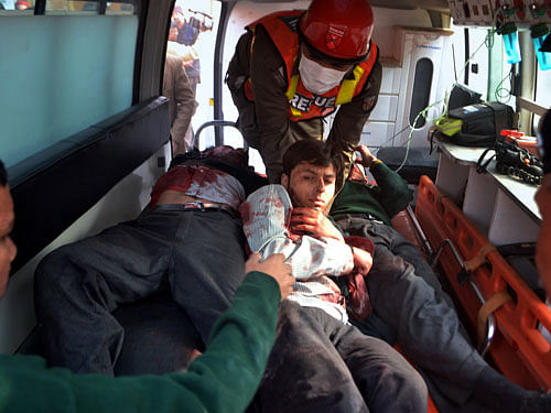 Pakistani rescue workers take out students from an ambulance who injured in the shootout at a school under attack by Taliban gunmen, upon arrival at a local hospital in Peshawar, Pakistan, Tuesday, Dec. 16, 2014. Taliban gunmen stormed a military school in the northwestern Pakistani city, killing and wounding dozens, officials said, in the latest militant violence to hit the already troubled region. AP Photo