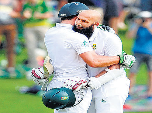two to tango SA's Hashim Amla (right) hugs AB&#8200;de Villiers after making a century against West Indies on Wednesday. AFP