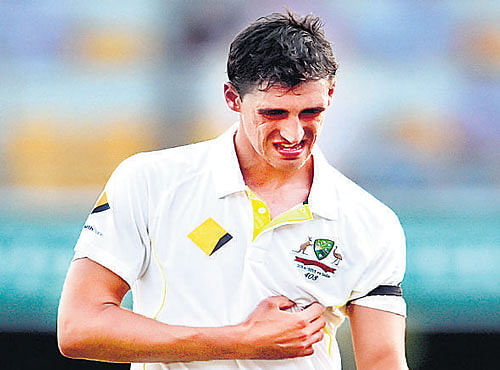 OUCH! Australia's Mitchell Starc grimaces in pain as he walks off the field onWednesday. Starc has a rib pain. REUTERS