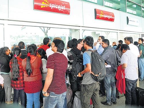 Passengers line up outside SpiceJet counters at the  Kempegowda International Airport on Wednesday. DH Photo