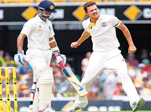 hit man: Australia's Josh Hazlewood (right) celebrates the wicket of India's Ajinkya Rahane on Thursday. reuters