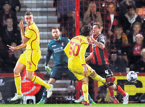 SUPERBCURLER: Liverpool's LazarMarkovic (centre) scores against Bournemouth during their League Cupmatch. AP