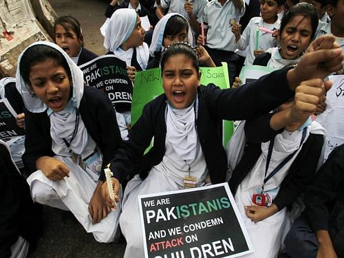 Pakistani schoolgirls chant slogans during a protest to condemn Tuesday's Taliban attack on a military-run school in Peshawar, in Karachi, Pakistan, Friday, Dec. 19, 2014. Pakistani jets and ground forces killed 67 militants in a northwestern tribal region near the Afghan border, officials said Friday, days after Taliban fighters killed 148 people - most of them children - in a school massacre. AP Photo