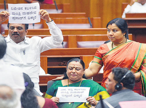 persistent demand: BJP legislators Vimala Gowda (centre), Somanna Bevinamarad (left) and Tara Anooradha stage a dharna in the Legislative Council in Belagavi on Friday, demanding the removal of "tainted" ministers. DH Photo