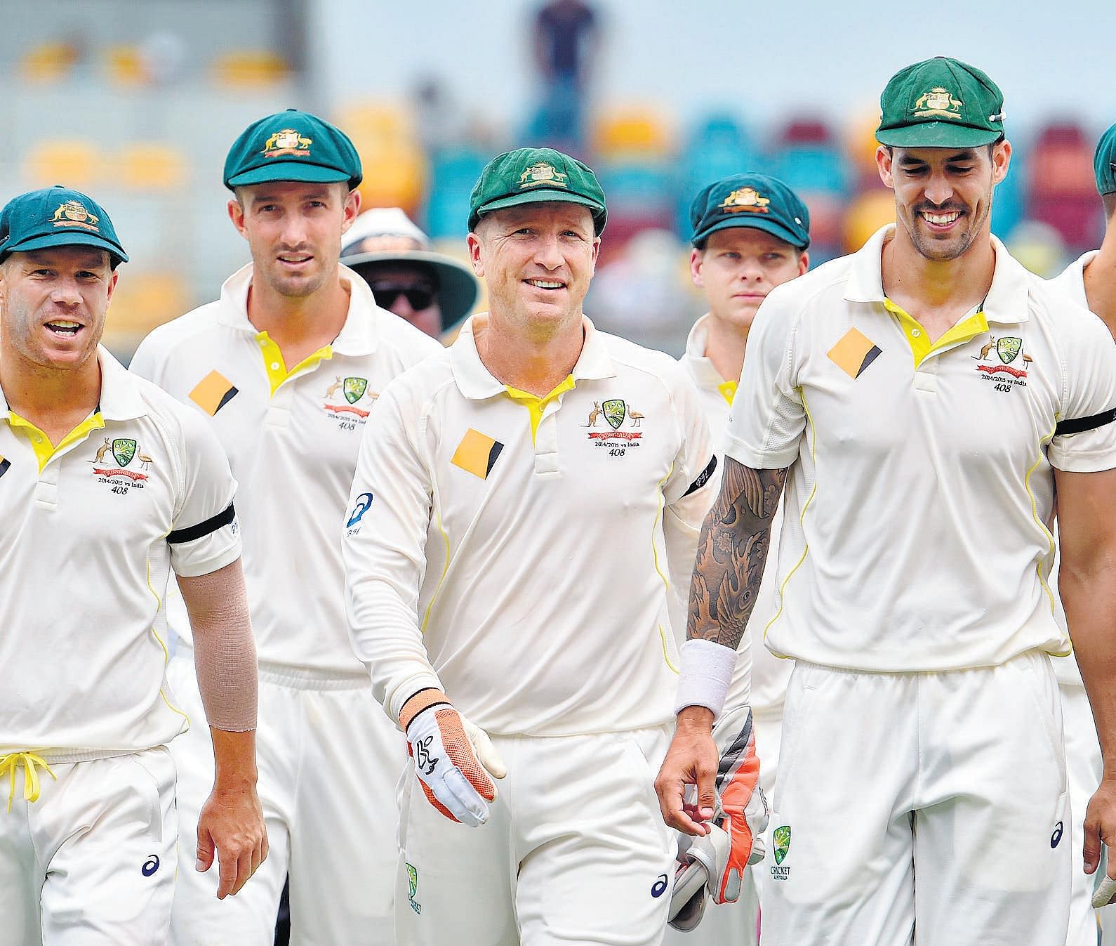 happy bunch: Australlia's Mitchell Johnson (second from right) leads his team out after taking four wickets against India on&#8200;Saturday. reuters