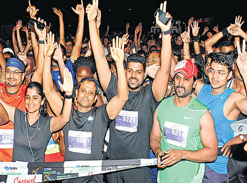 night of action Regasa Mindaye Bejiga (top left) Alents E Hay en route to winning the men's and women's races in the SBI Bengaluru Midnight Marathon. People, who came out in numbers, enjoy their run. DH photo