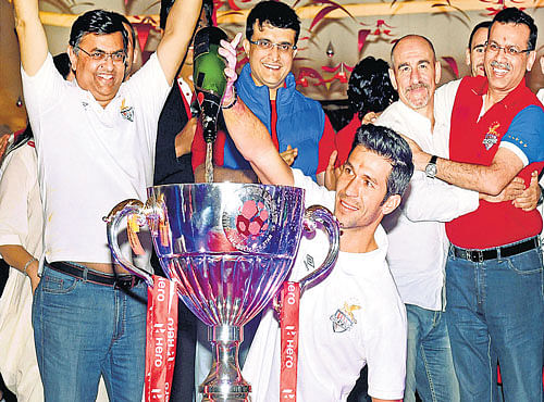 champagne time: Atletico de Kolkata players and co-owners, including Sourav Ganguly,  celebrate the team's triumph in the inaugural ISL. pti