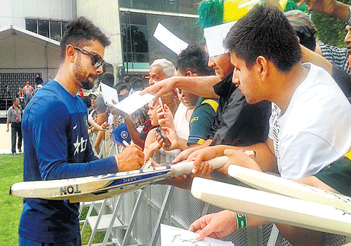 most sought after: India's Virat Kohli signs autographs at MCG&#8200;on Tuesday. BCCI