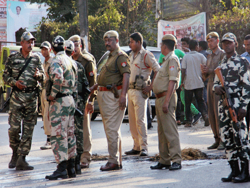 Police personnel take guard after members of All Adivasi Students Association blocked National Highway at Margherita after the attacks by NDFB, in Margherita on Wednesday. PTI Photo
