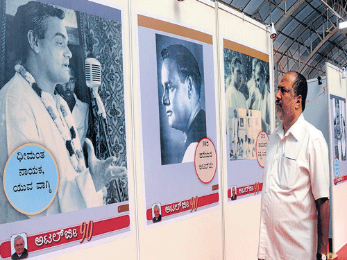 Visitors look at the photographs of former prime minister Atal Bihari Vajpayee at an  exhibition organised to mark his 90th birthday in Bengaluru on Wednesday. dh Photo