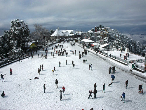 People enjoy with snow at historic Ridge Road after heavy snowfall in Shimla. Asia's oldest skating clay surface rink in this Himachal Pradesh hill town had a natural coating of thick ice for the first time Friday in this season, thanks to the freezing winter. PTI photo