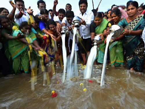 Fishermen pour milk into the sea to mark the 10th anniversary of Tsunami at Marina beach in Chennai on Friday. PTI Photo