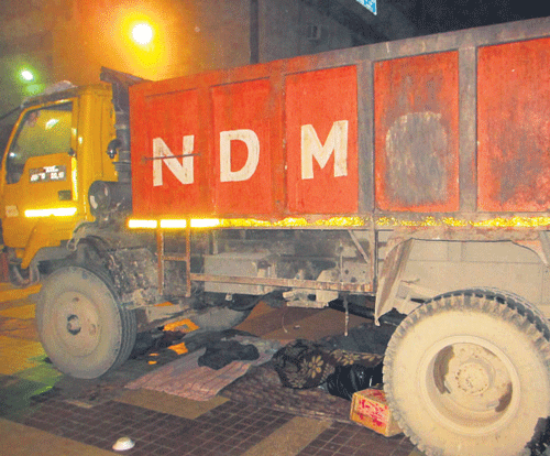 Homeless persons are forced to take refuge under parked vehicles to save themselves from the freezing cold in the national capital. Some destitutes were seen sleeping under a parked garbage truck at the Hanuman Mandir in Connaught Place.