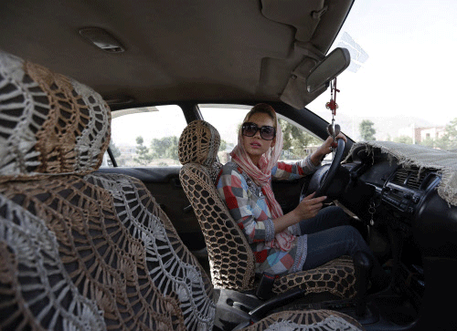 Kanaz, 21, listens to her instructor (unseen) during a practical driving lesson in Kabul August 14, 2014. Kabul is one of the world's fastest growing cities and its streets are increasingly blocked by cars and buses. In the city's private driving schools, students pay a $60 fee for a 45-day course, which includes oral and practical driving tests at the country's Traffic Department. Some of the women who have signed up say learning to drive is a way to escape unwanted gazes and physical harassment on the cramped, crowded minibuses that are often the only method of urban public transport. REUTERS