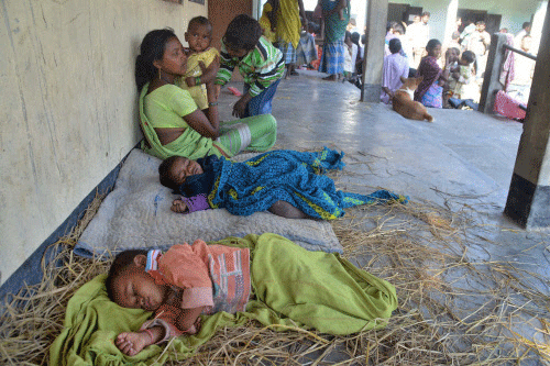 Victims sleep at a relief camp after the families were forced to leave their villages following National Democratic Front of Bodoland attacks, in Sonitpur on Saturday. PTI Photo