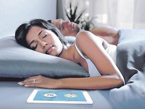 A handout of Sleep Number bed with SleepIQ sensing pad, and the SleepIQ app on a tablet. The mattress pad captures data like your heart rate, respiration and movements, while the free app displays a sleep score.  INYT