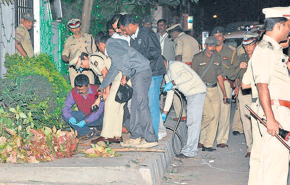 The police investigate the blast site in front of Coconut Groves on Church Street in Bengaluru on Sunday. DH Photo