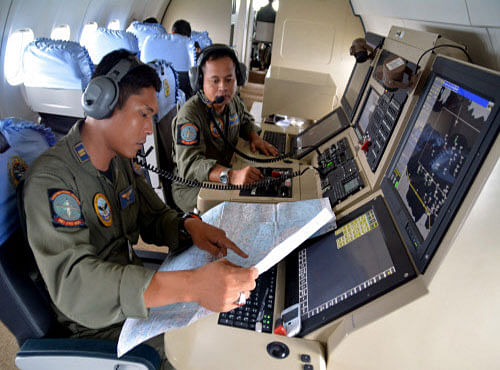 Members from the Indonesian Navy's Tactical Commanding Operator help with the search for AirAsia flight QZ 8501on board a CN235 aircraft over Karimun Java in the Java Sea. Reuters
