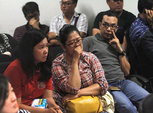 Relatives of the passengers of AirAsia flight QZ8015 wait for the latest news on the search of the missing jetliner at Juanda International Airport in Surabaya, East Java, Indonesia,