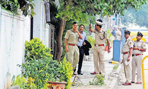 Senior police officers Alok Kumar, Abhishek Goyal and others inspect the bomb blast site outside Coconut Grove restaurant on Church Street in Bengaluru on Monday.