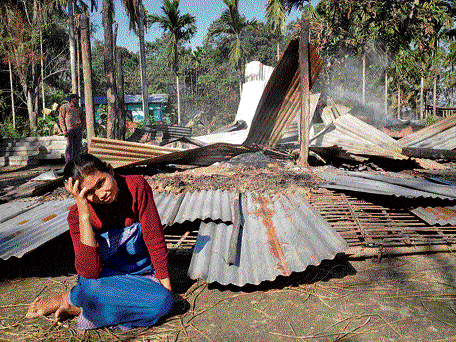 Phoolmati Musahary at Mainaopur village of upper Assam in front of her burnt house, which was set on fire by Adivasis on December 24. DH PHOTO/DRIMI CHAUDHURI