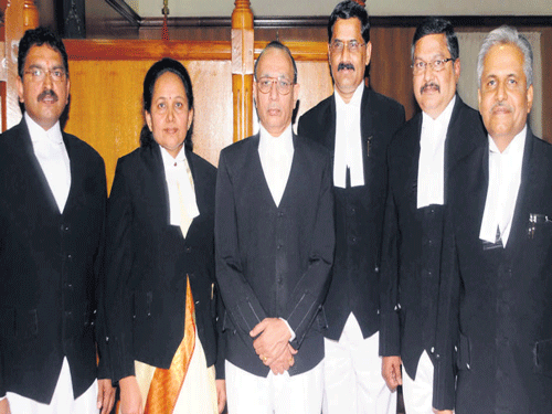 Newly sworn in  additional High Court judges (from left) Justice Pawan Kumar Bhajantri, Justice Sujatha S, Justice B Veerappa, Justice Narendra Guha and Justice Dinesh Kumar P S with  Chief Justice D H Waghela (3rd from left) after their swearing in at the High Court in Bengaluru on Friday. DH Photo
