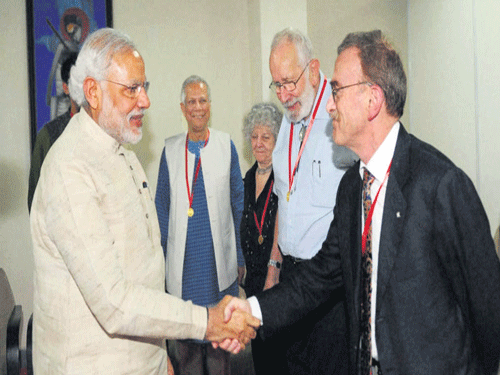 United by passion: Prime Minister Narendra Modi shakes hands with Nobel laureate Randy Wayne Schekman as other  Nobel Laureates (from left) Muhammad Yunus, Ada E Yonath and Kurt Wuthrich look on at the 102nd Indian Science Congress in Mumbai on Saturday. PTI