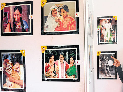 Students have a look at the photographs at an exhibition on Kannada films at the Maharani Women's Arts College in the City on Monday. dh photo